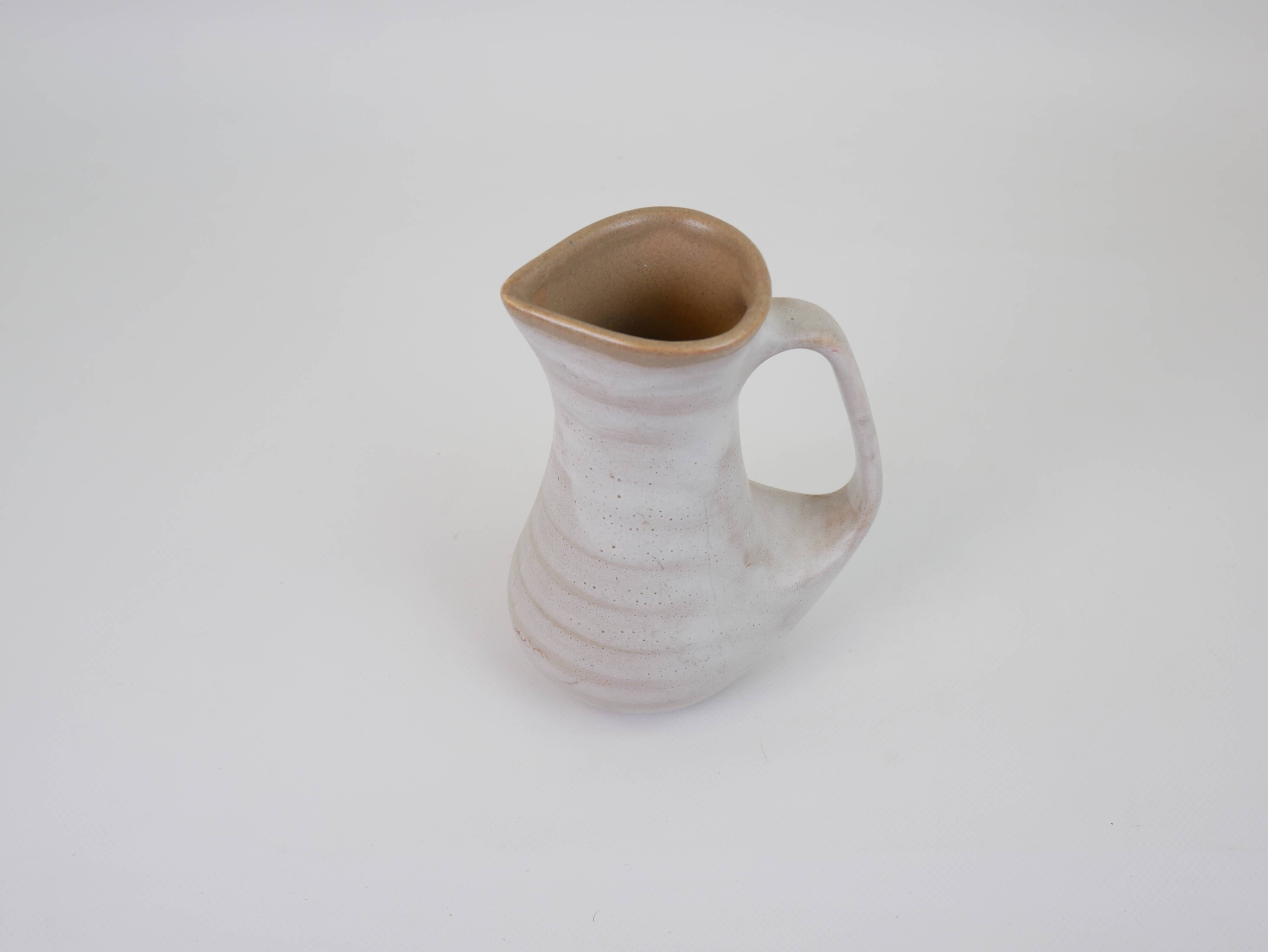 Signed white beige ceramic pitcher