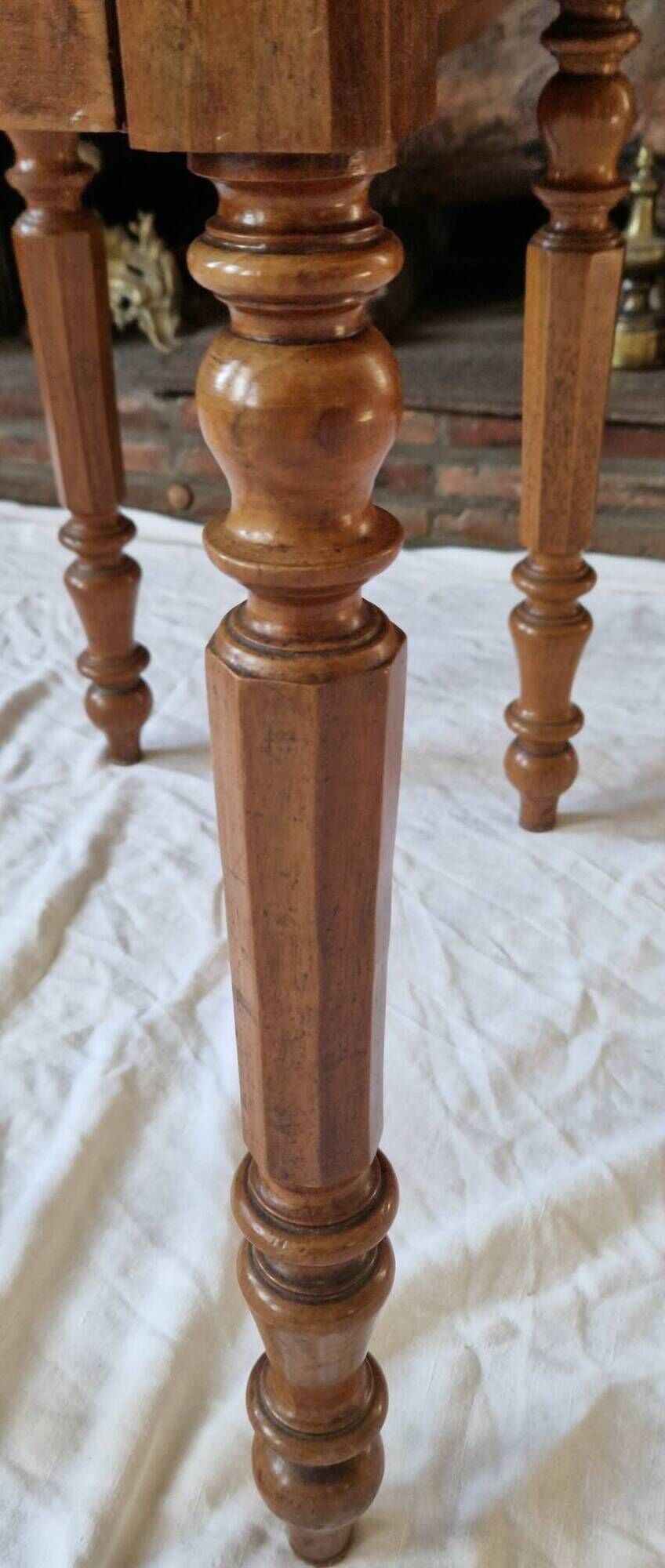 Nineteenth-century walnut work table with flaps, large storage + secret drawer.