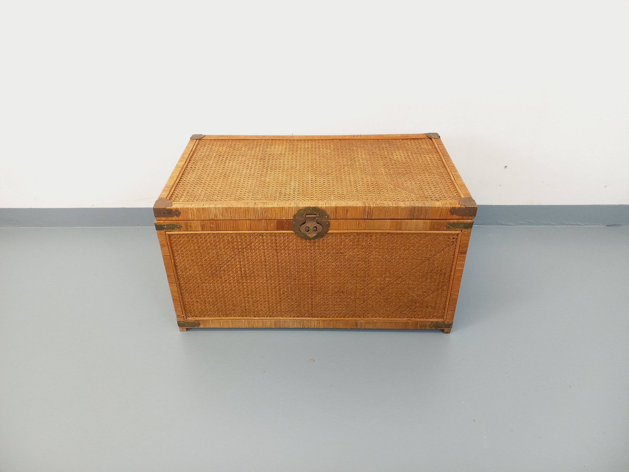 Vintage trunk in wood, rattan, caning, and brass.