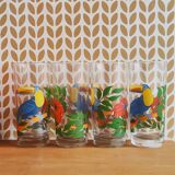 Vintage lemonade glasses with tropical parrot and flower patterns.