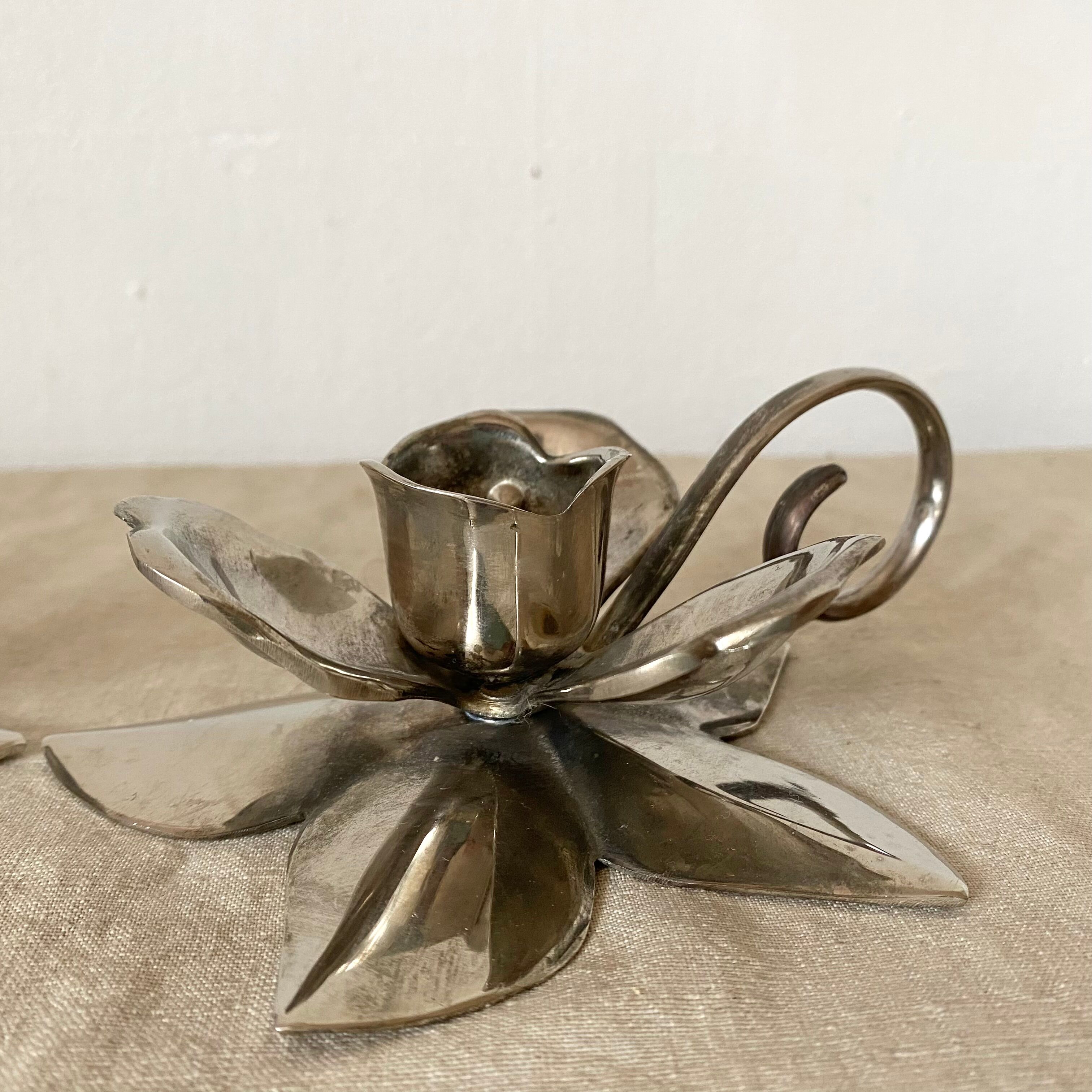 Pair of silver metal flower candle holders