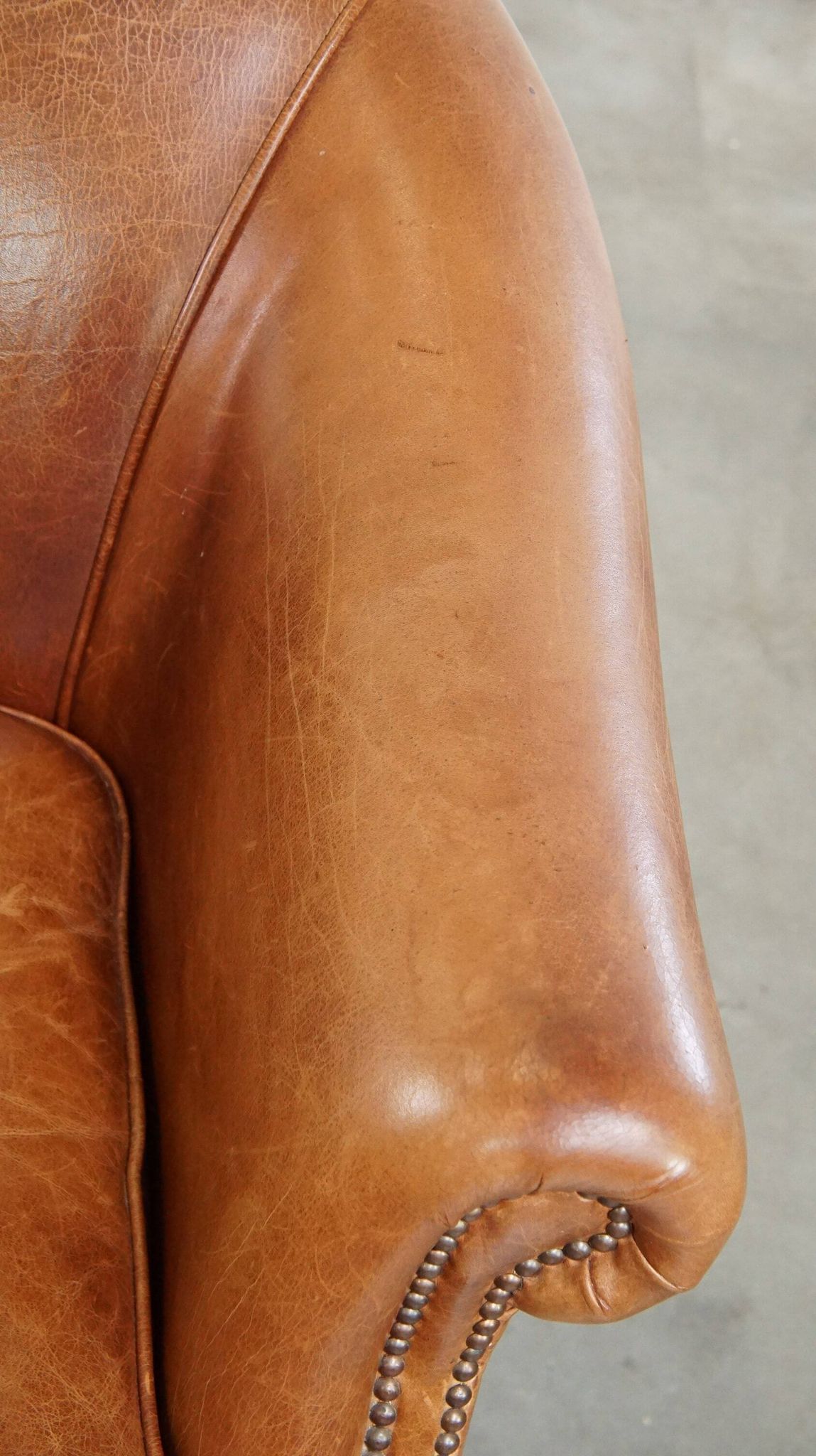 Very comfortable, elegant leather club armchair with a removable seat cushion and timeless design