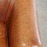 Very comfortable, elegant leather club armchair with a removable seat cushion and timeless design
