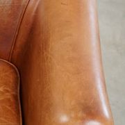 Very comfortable, elegant leather club armchair with a removable seat cushion and timeless design