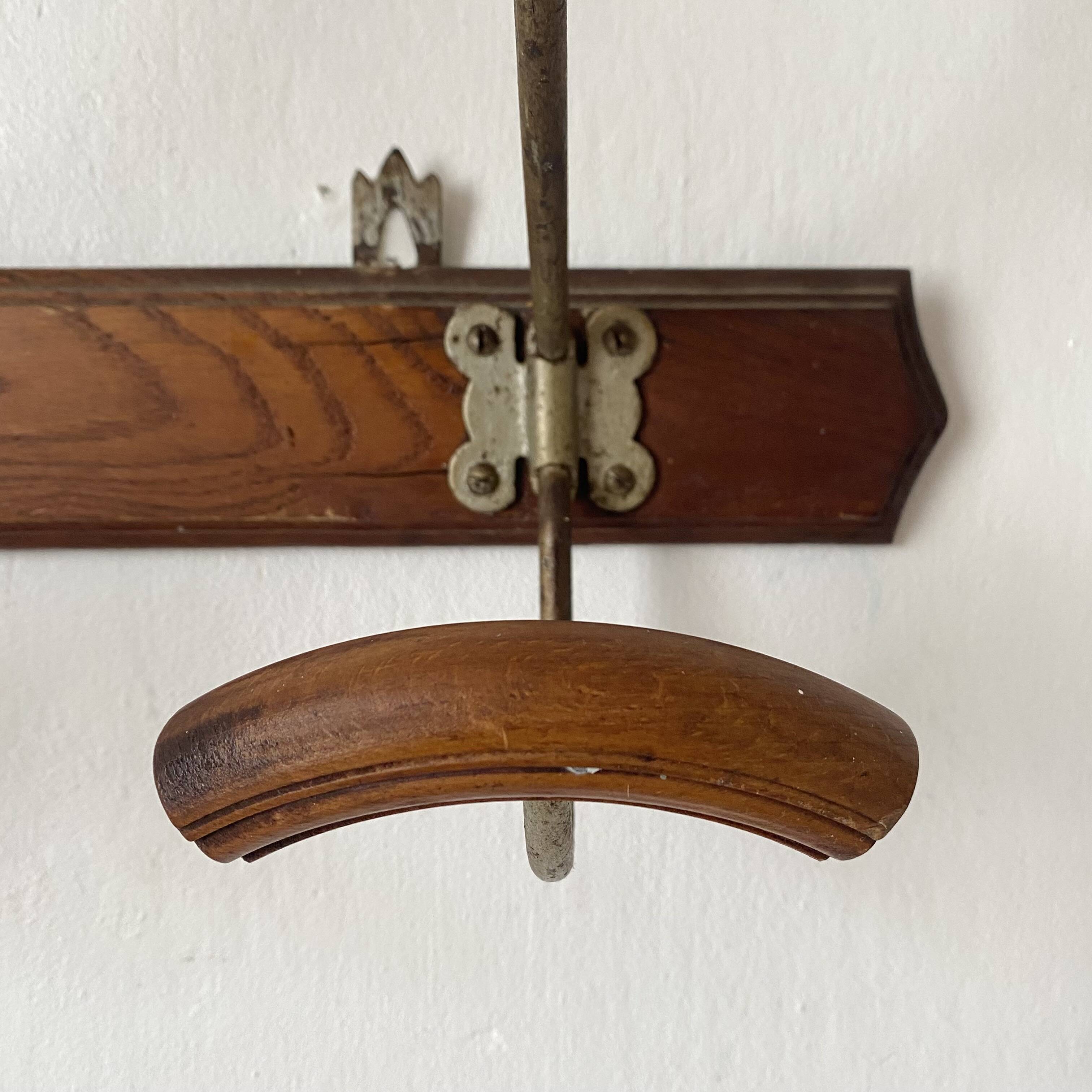 Antique wall-mounted coat rack in wood and metal