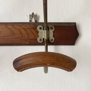 Old wooden and metal wall-mounted coat rack.