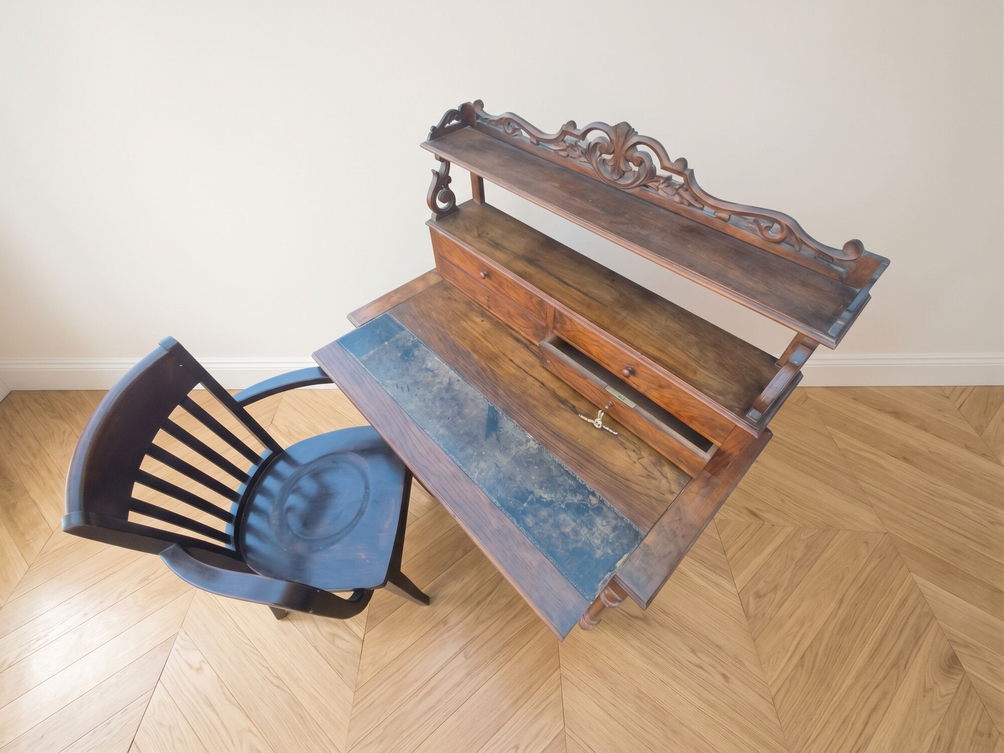 Old wooden tiered desk and its matching chair.
