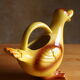 Ceramic watering can in white earthenware, yellow enamel and bird shape
