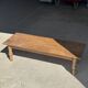 Brown Indonesian teak coffee table, with a border and cylindrical legs H40 L103.