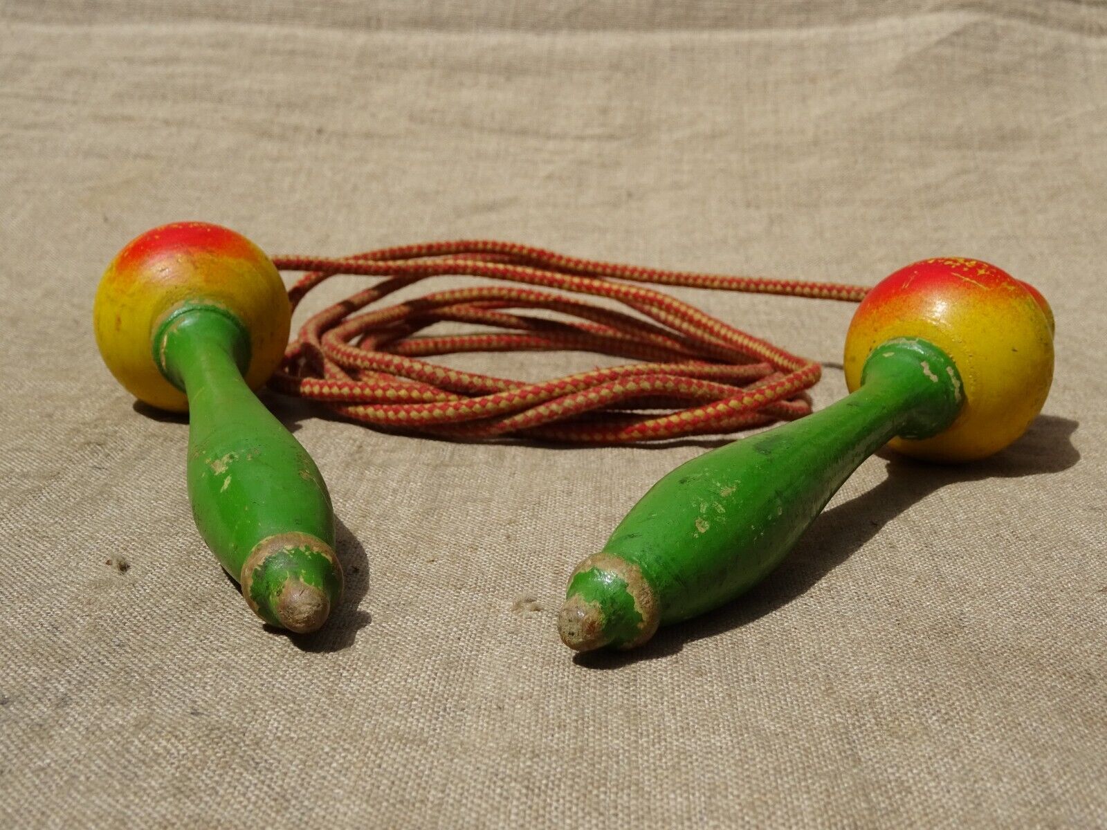Old wooden jump rope toy painted in the shape of pear fruit ref