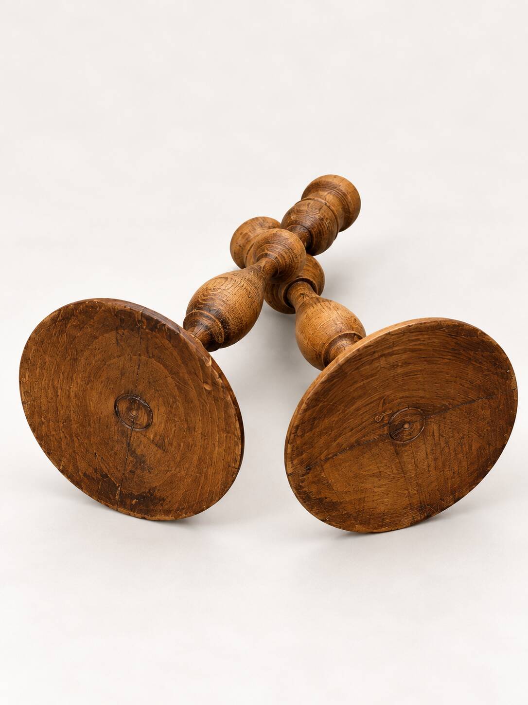 Pair of antique turned wooden candlesticks