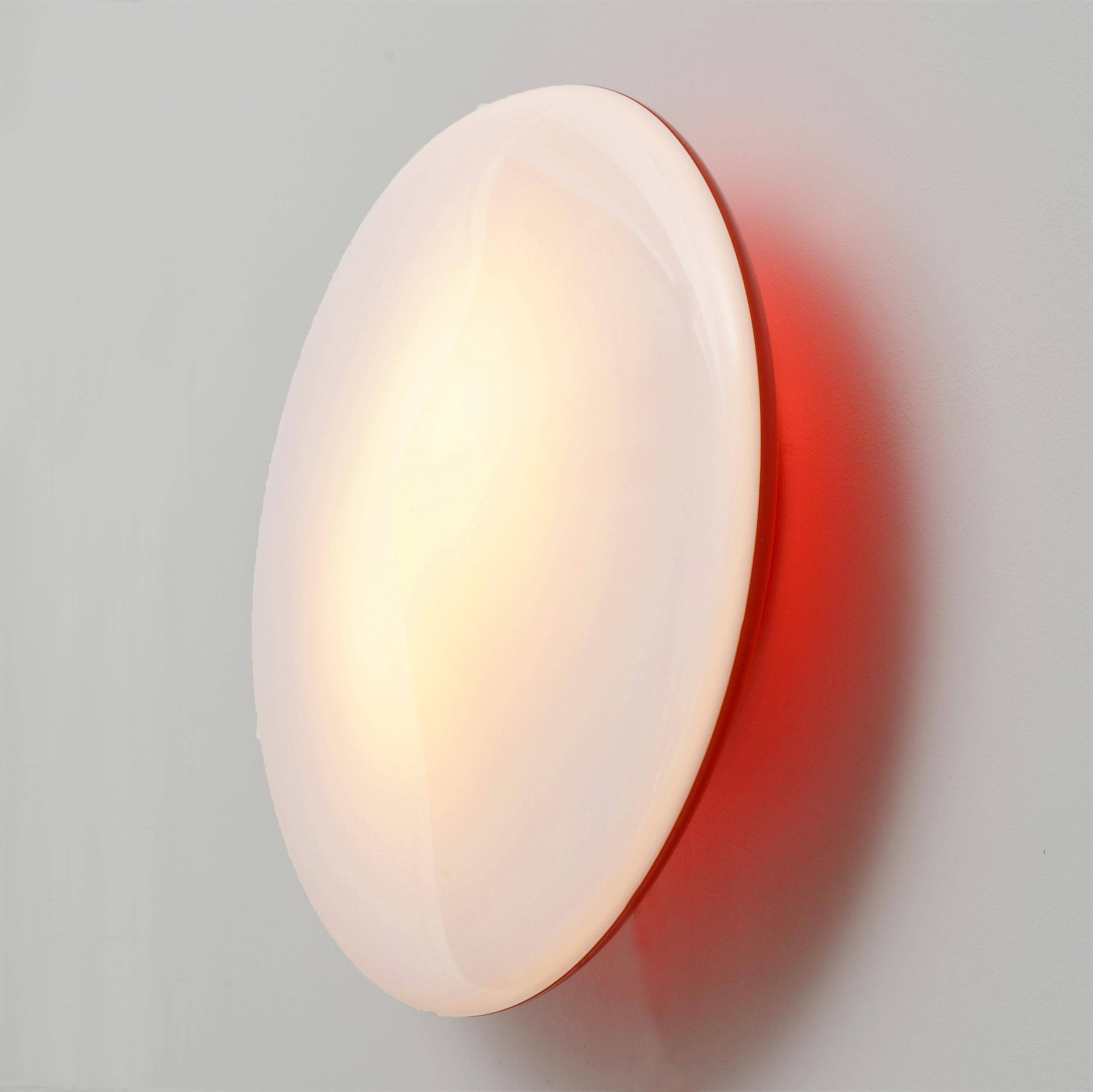 Oval wall lamp Artemide Italy design Patrick Jouin orange and white.