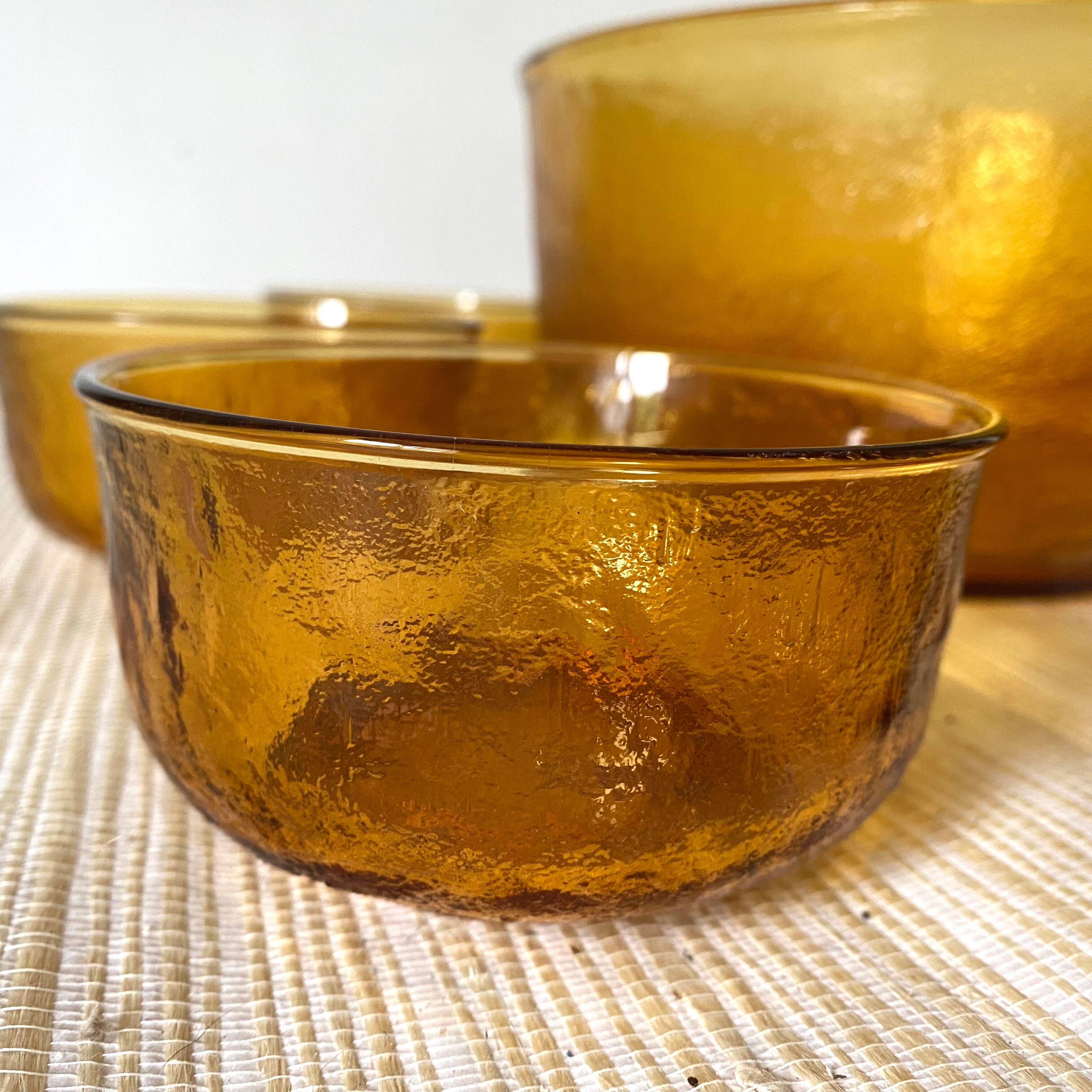 Salad bowl and bowls in amber glass, 70s