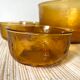 Salad bowl and bowls in amber glass, 70s