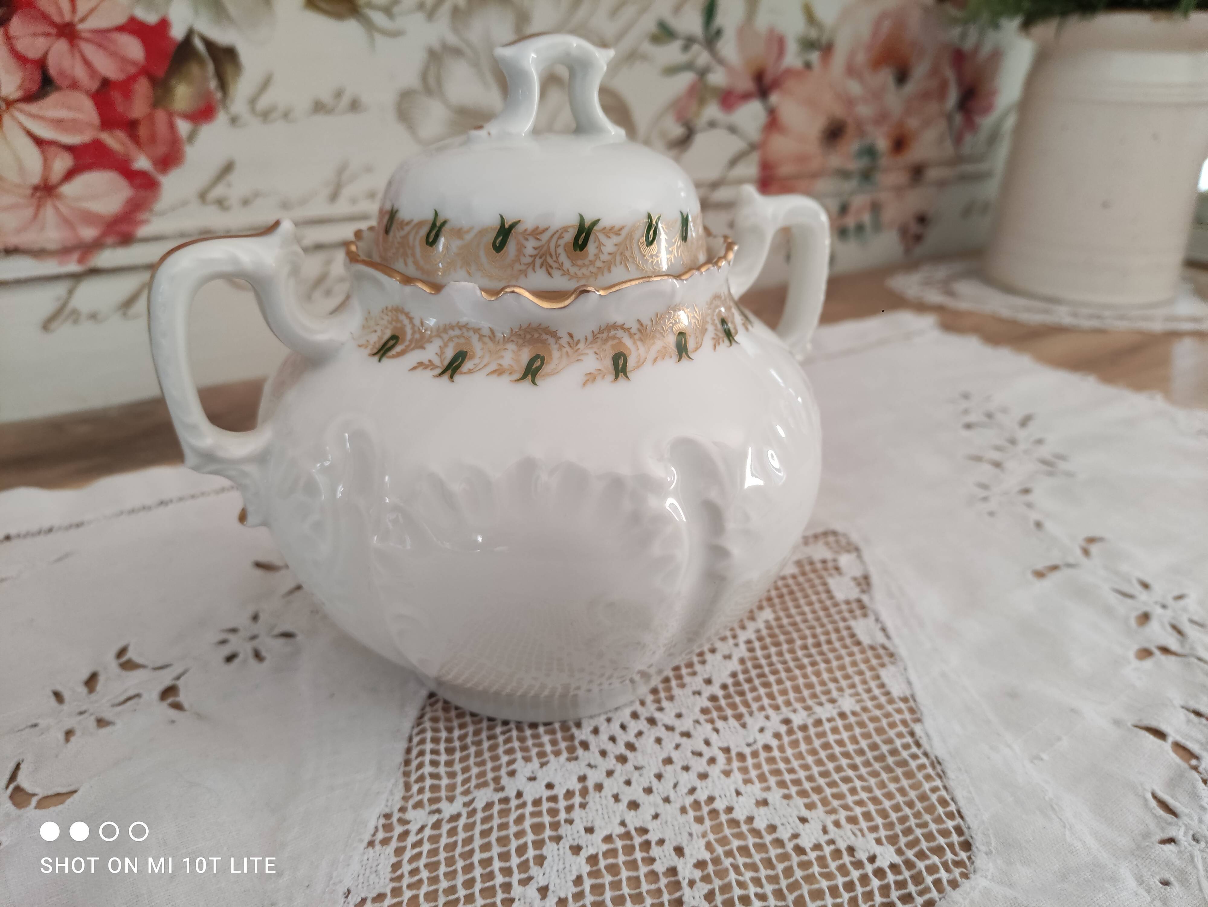 White porcelain sugar bowl decoration in relief and green and gold frieze