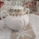 White porcelain sugar bowl decoration in relief and green and gold frieze