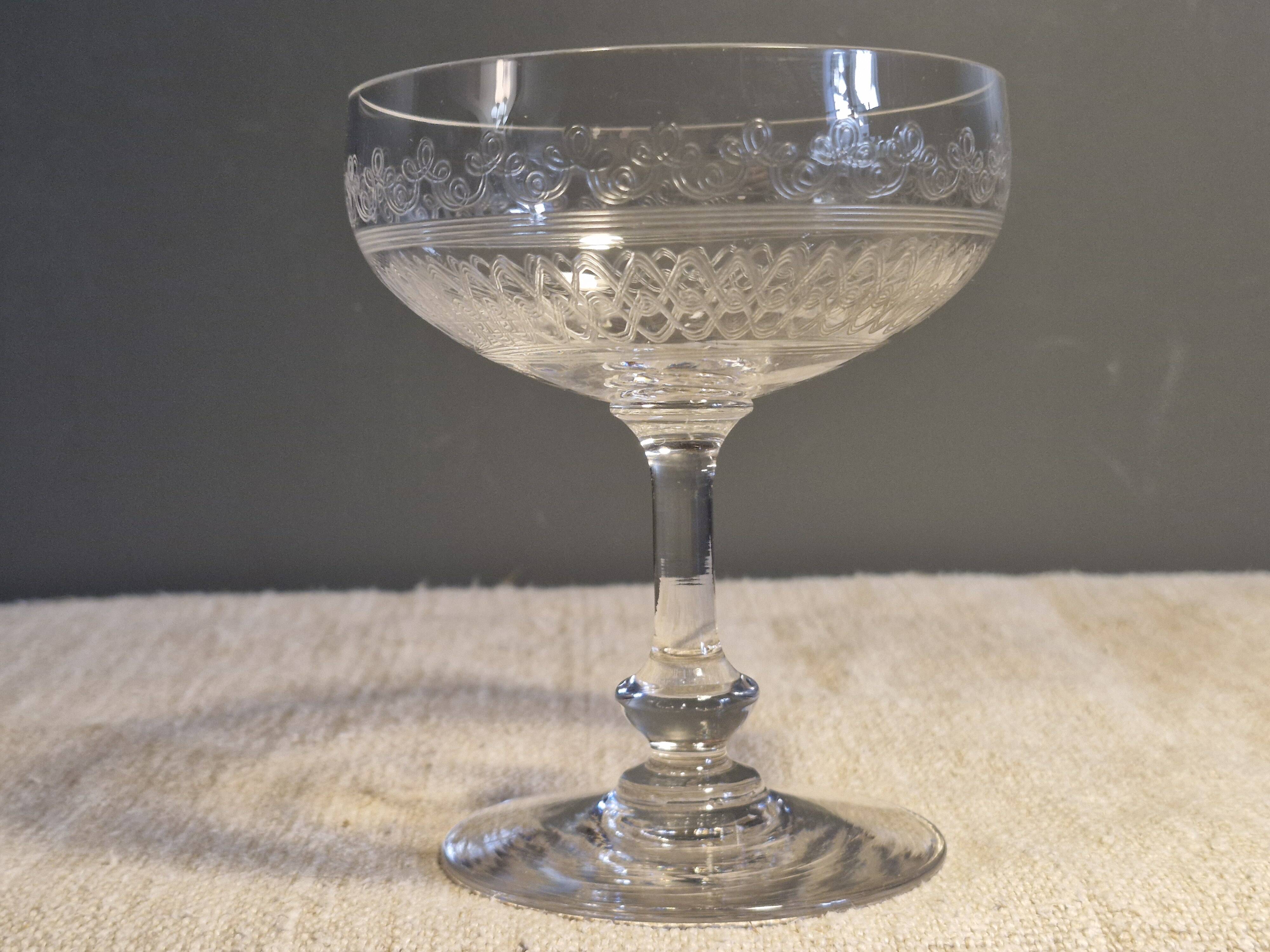 8 antique Baccarat crystal champagne coupes with engraved decoration.