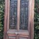 Oak entrance door and its frame and transom, wrought iron gates