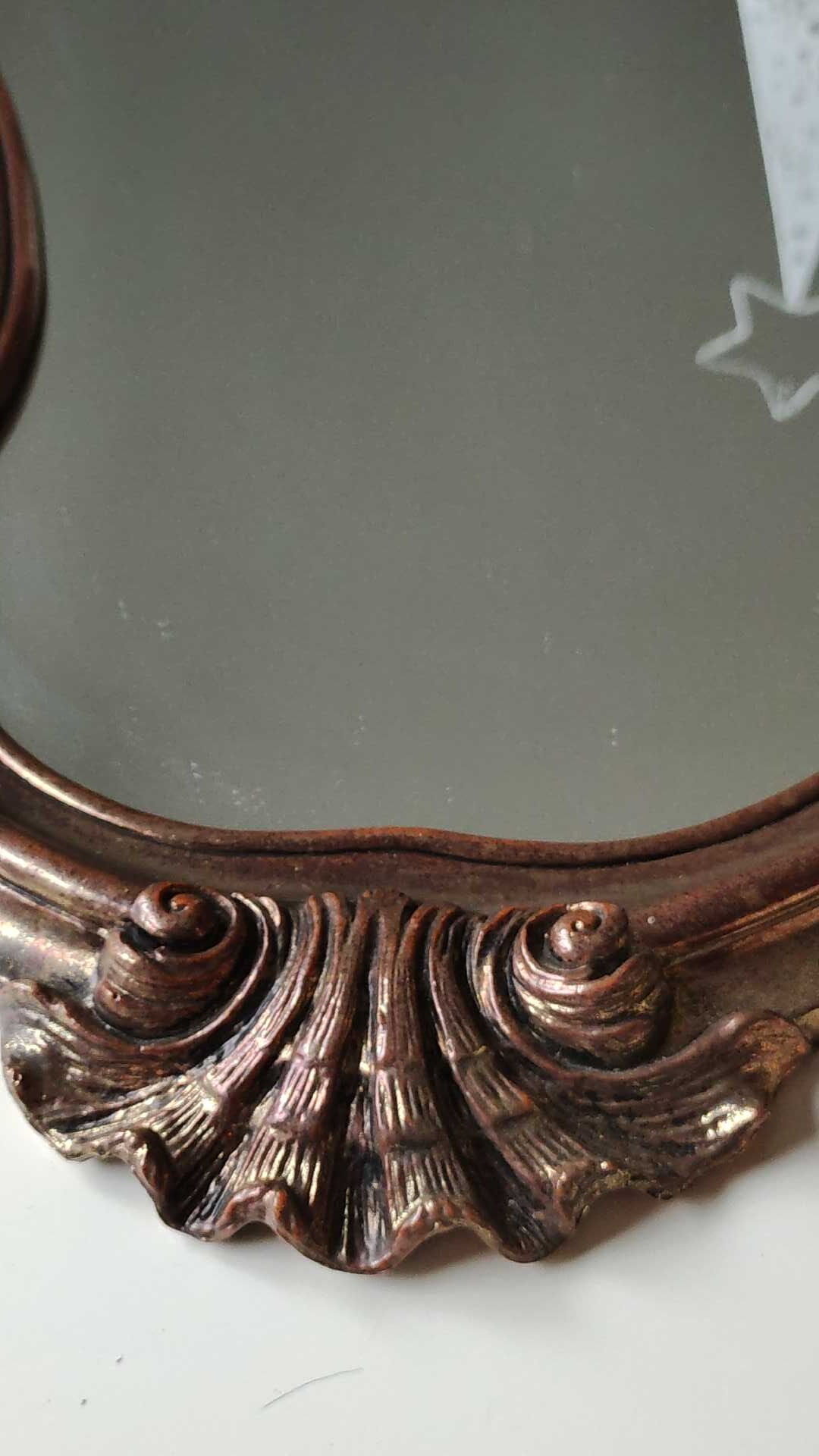 Pretty Baroque style mirror / Louis XV patinated with pink / golden copper reflections. Volutes, leafy shells