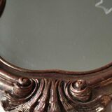 Pretty Baroque style mirror / Louis XV patinated with pink / golden copper reflections. Volutes, leafy shells