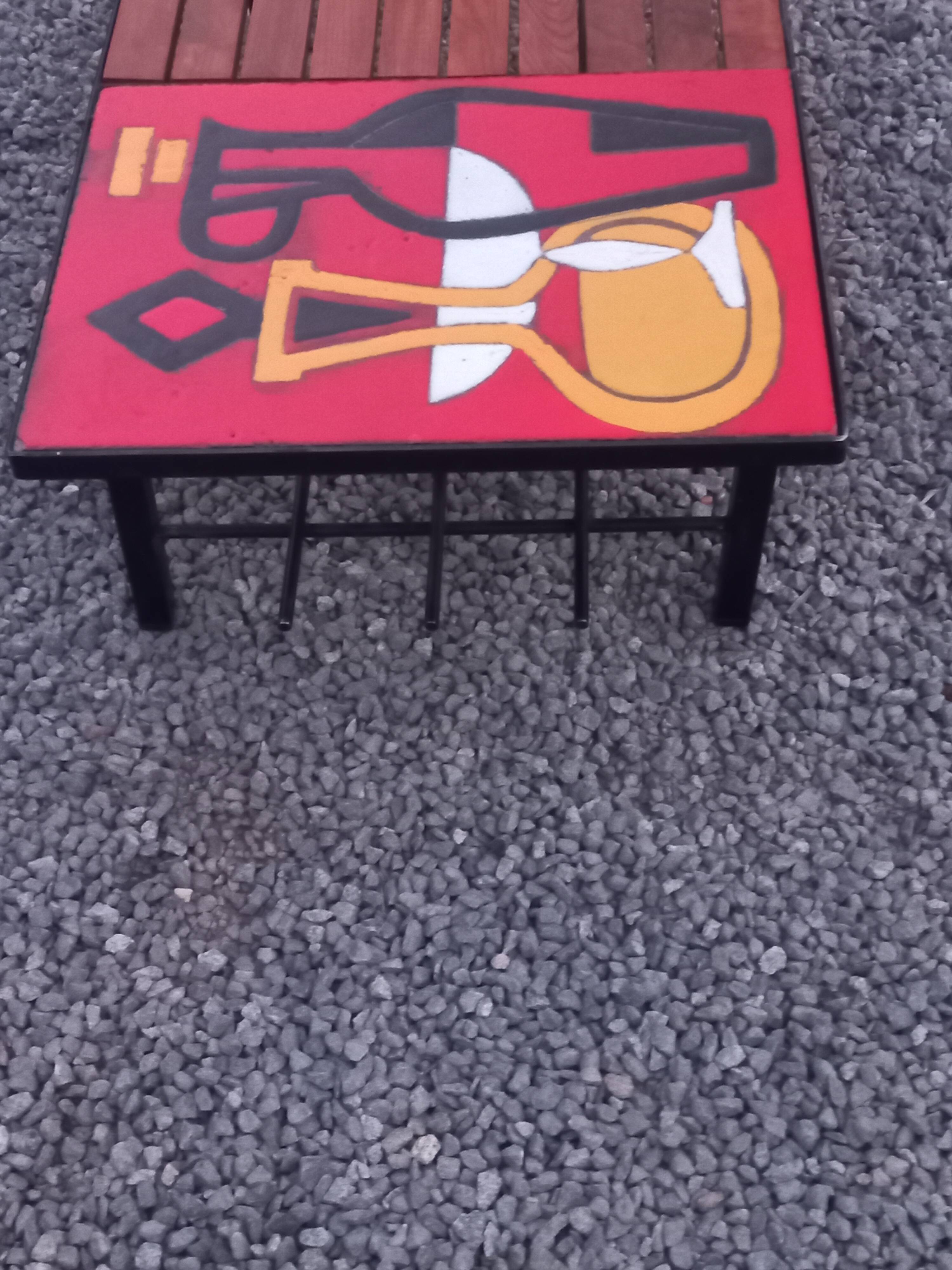 1970s design coffee table with ceramic and wood top, metal legs.