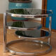 Coffee table with pivoting metal and black glass elements.