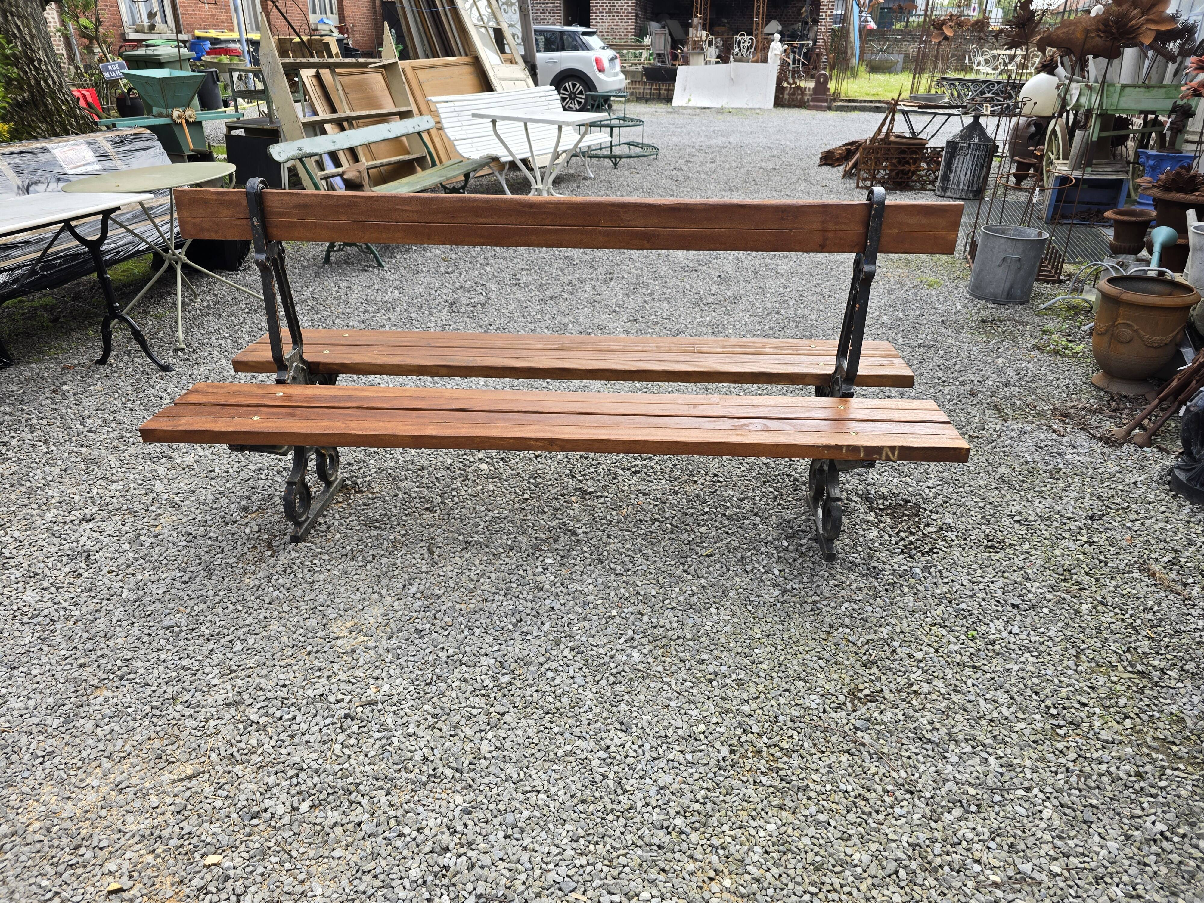 Antique double garden bench from the city of Paris in cast iron and wood