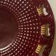 Burgundy and gold openwork plate in ceramic from Saint-Clement, 1950s.