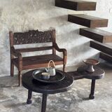 Small antique Indonesian bench in carved teak with plant and floral motifs.