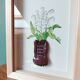 Composition of a bouquet of lilies of the valley in a shoe-shaped clay pot