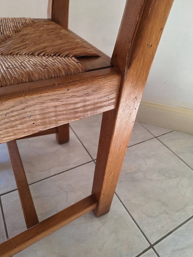 Set of 6 solid oak chairs with straw seats.