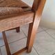 Set of 6 solid oak chairs with straw seats.