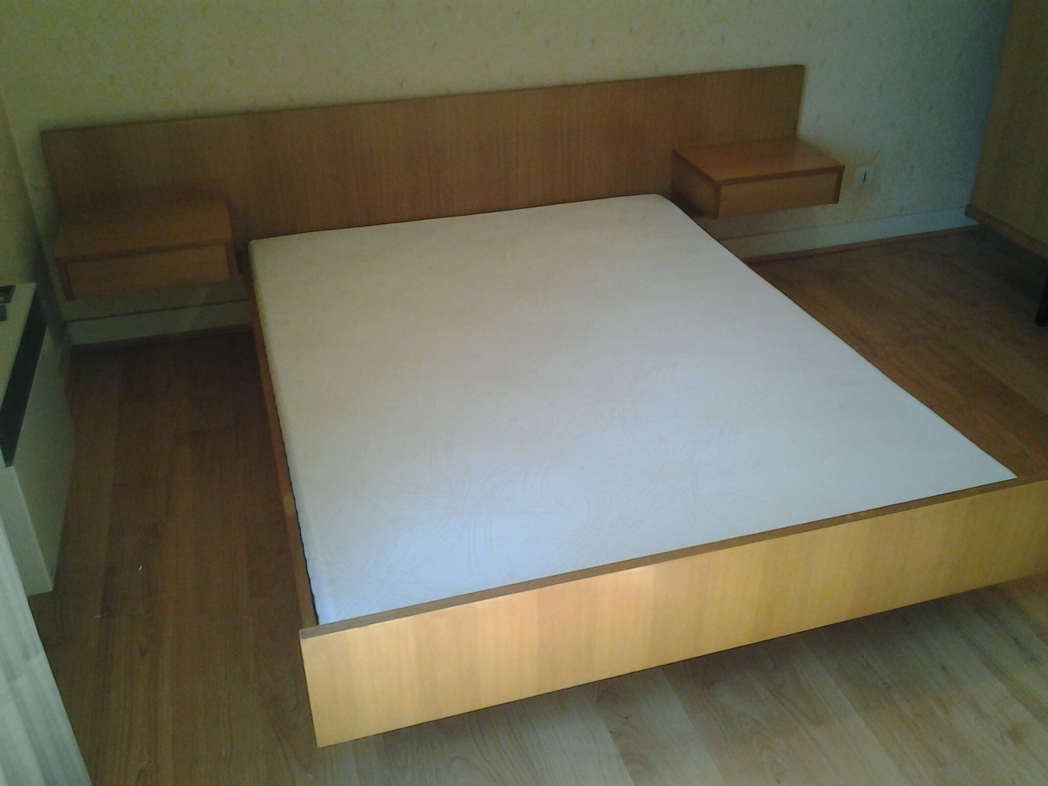 Bed with integrated bedside tables