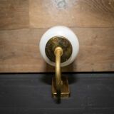 Ornate wall lamp made of milk glass and brass