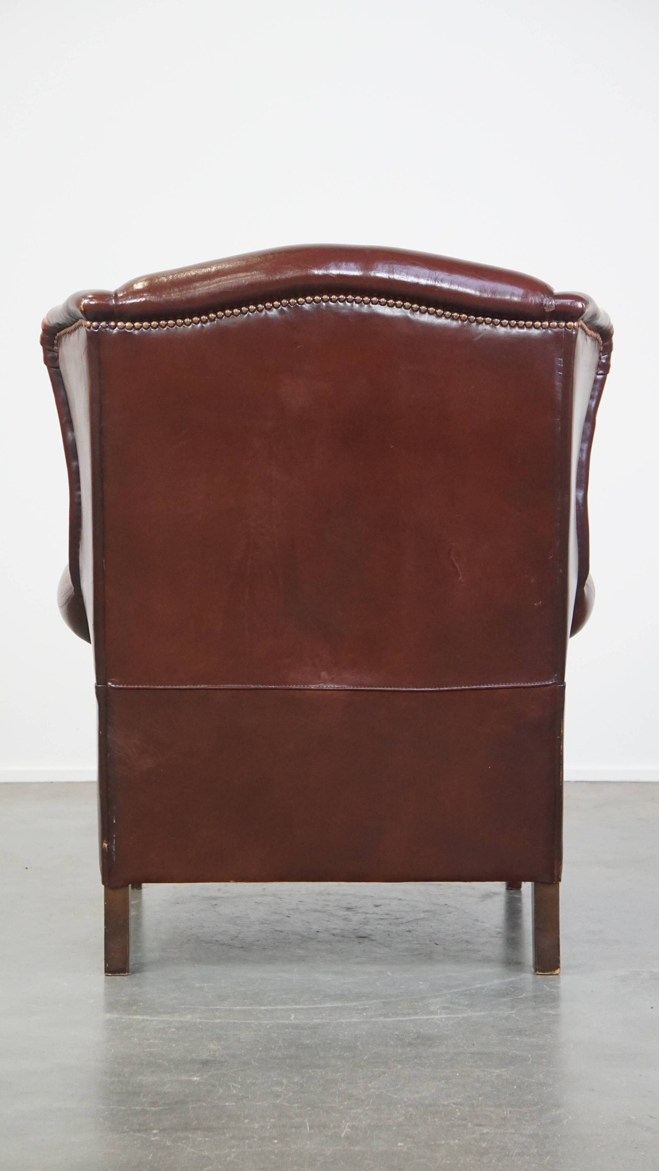 Dark English style sheepskin wingback chair with character and patina