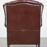 Dark English style sheepskin wingback chair with character and patina