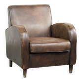 Comfortable sheepskin armchair with matching piping and a timeless look