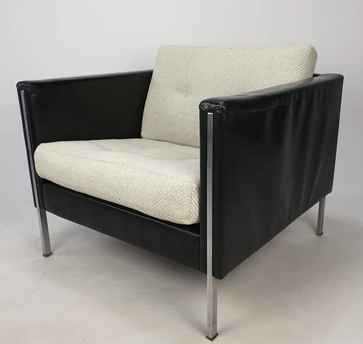 Pair of armchairs by Pierre Paulin for Artifort, black leather and cream fabric.