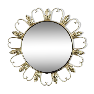Round mirror on scrolled brass frame