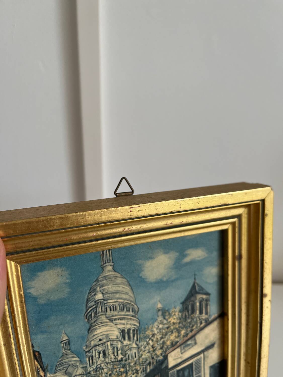 Reproduction of a painting of a walk in the city center by Maurice Trillon