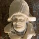 Marble sculpture, man's head in a hat.
