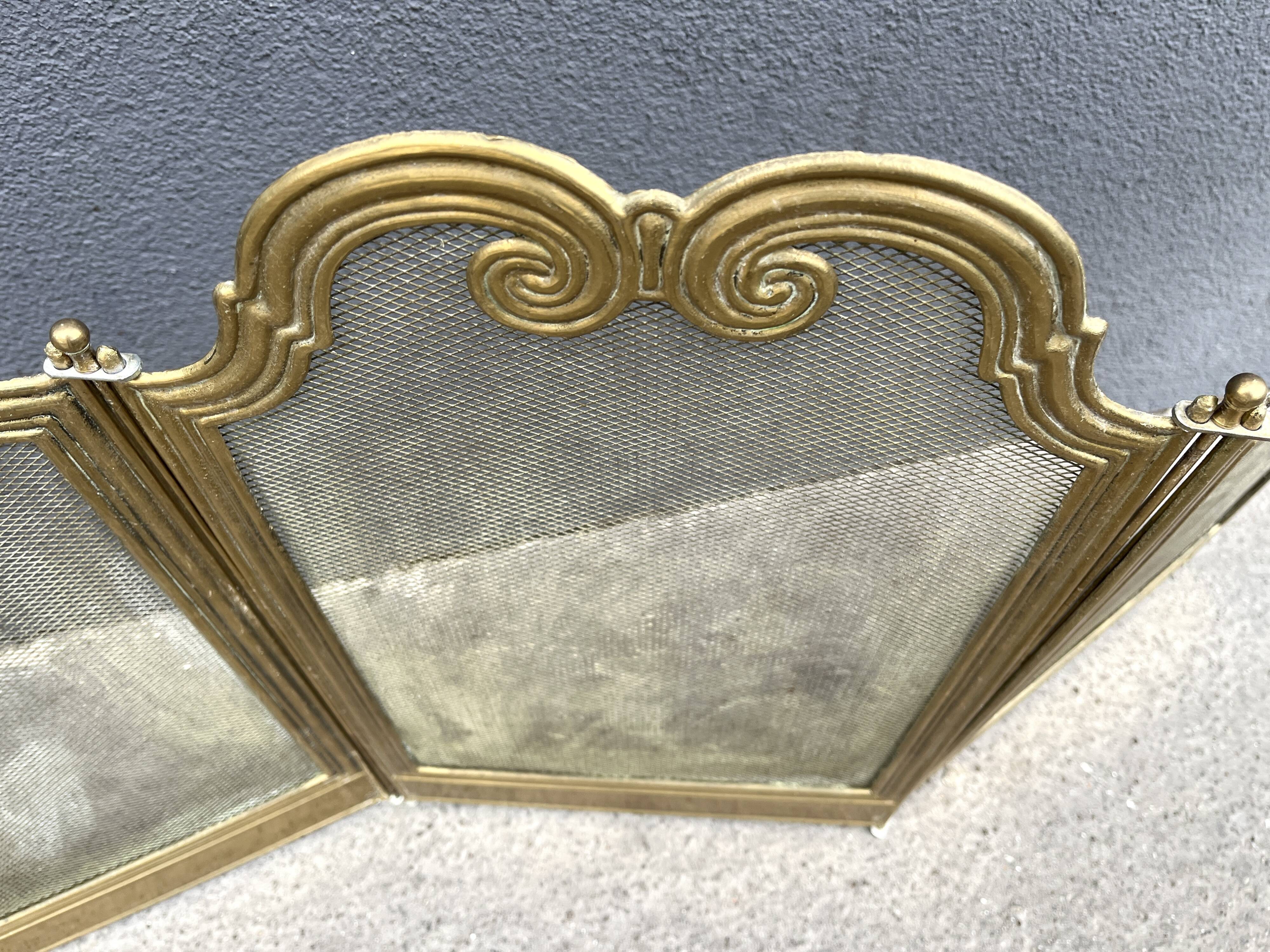 Antique brass fireplace screen from 1920, vintage spark guard.