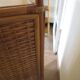 Storage column, wooden bookshelf and woven rattan.