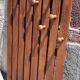 Wall-mounted coat rack in wood or wall hook.