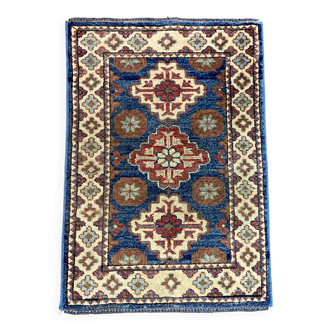 Oriental rug on a blue Kazak background in wool, handmade in Kazakhstan