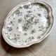 Oval Moustiers plate in cream and green earthenware, 18th century.