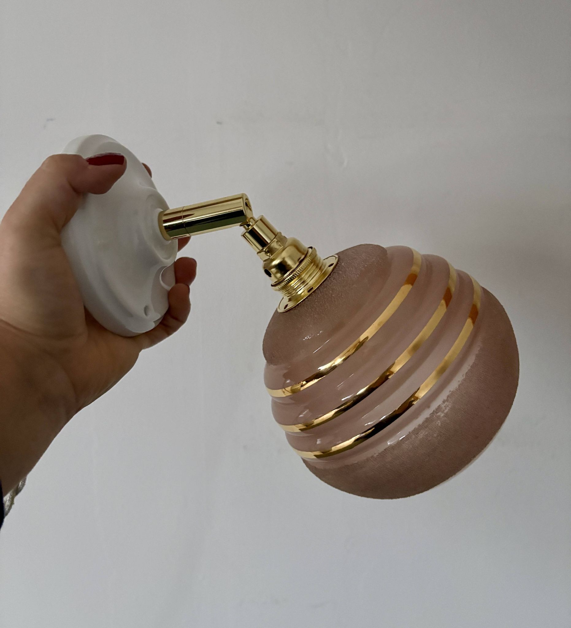 Vintage globe wall light in frosted pink and gold glass.