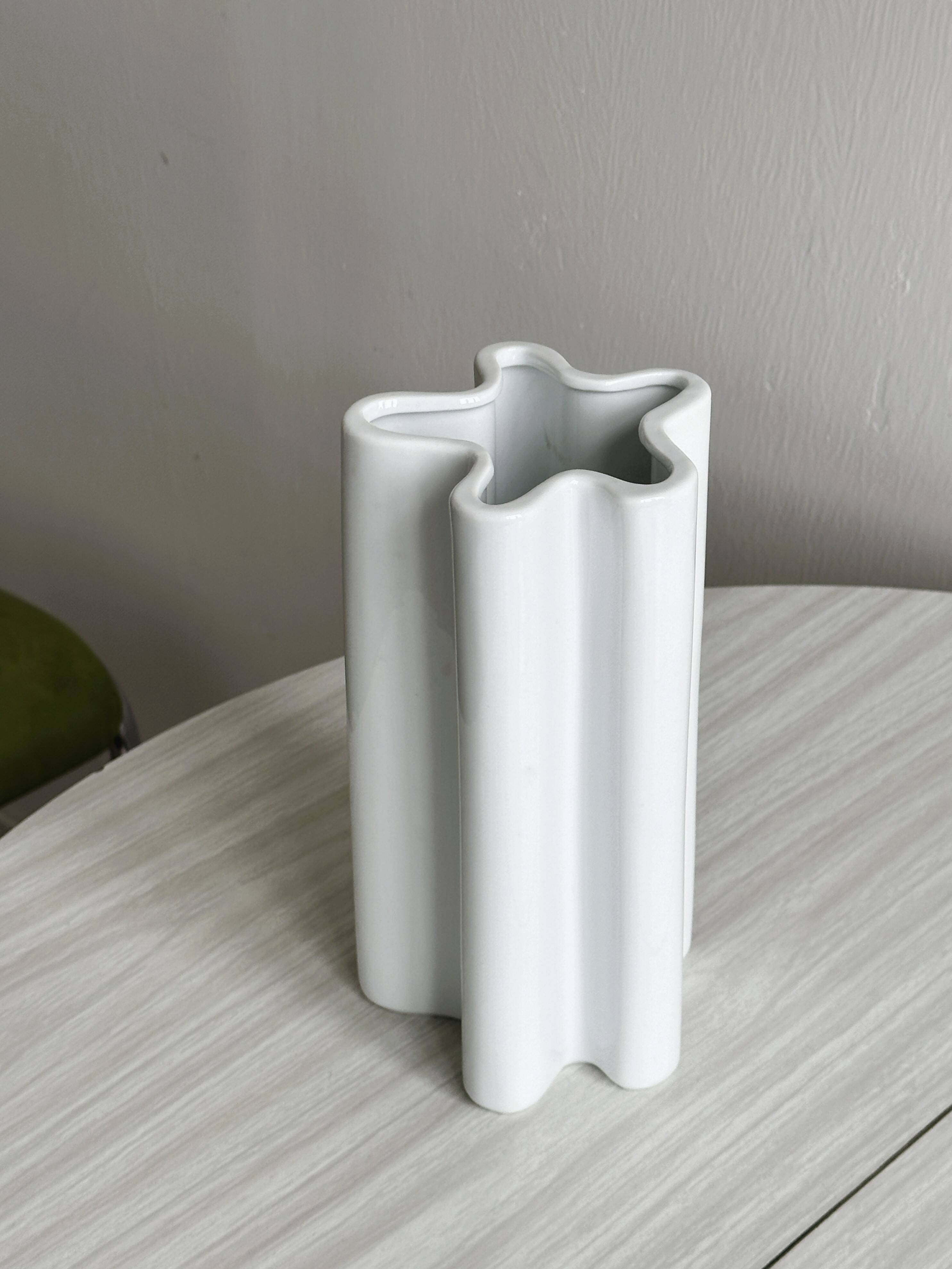 Modern white ceramic vase with wavy curves