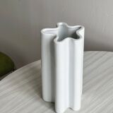 Modern white ceramic vase with wavy curves