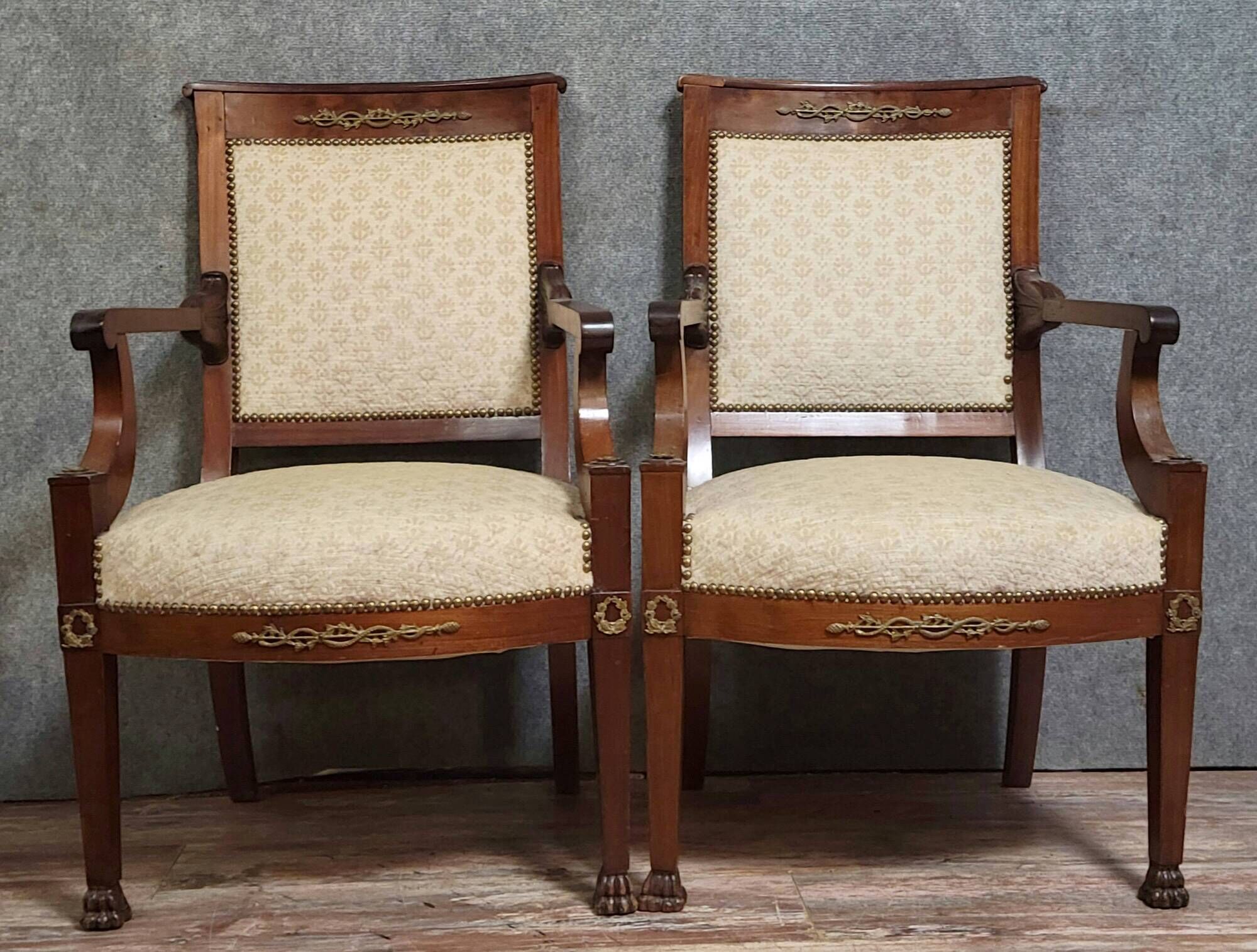 Pair of Empire period armchairs, in mahogany and gilded bronze.